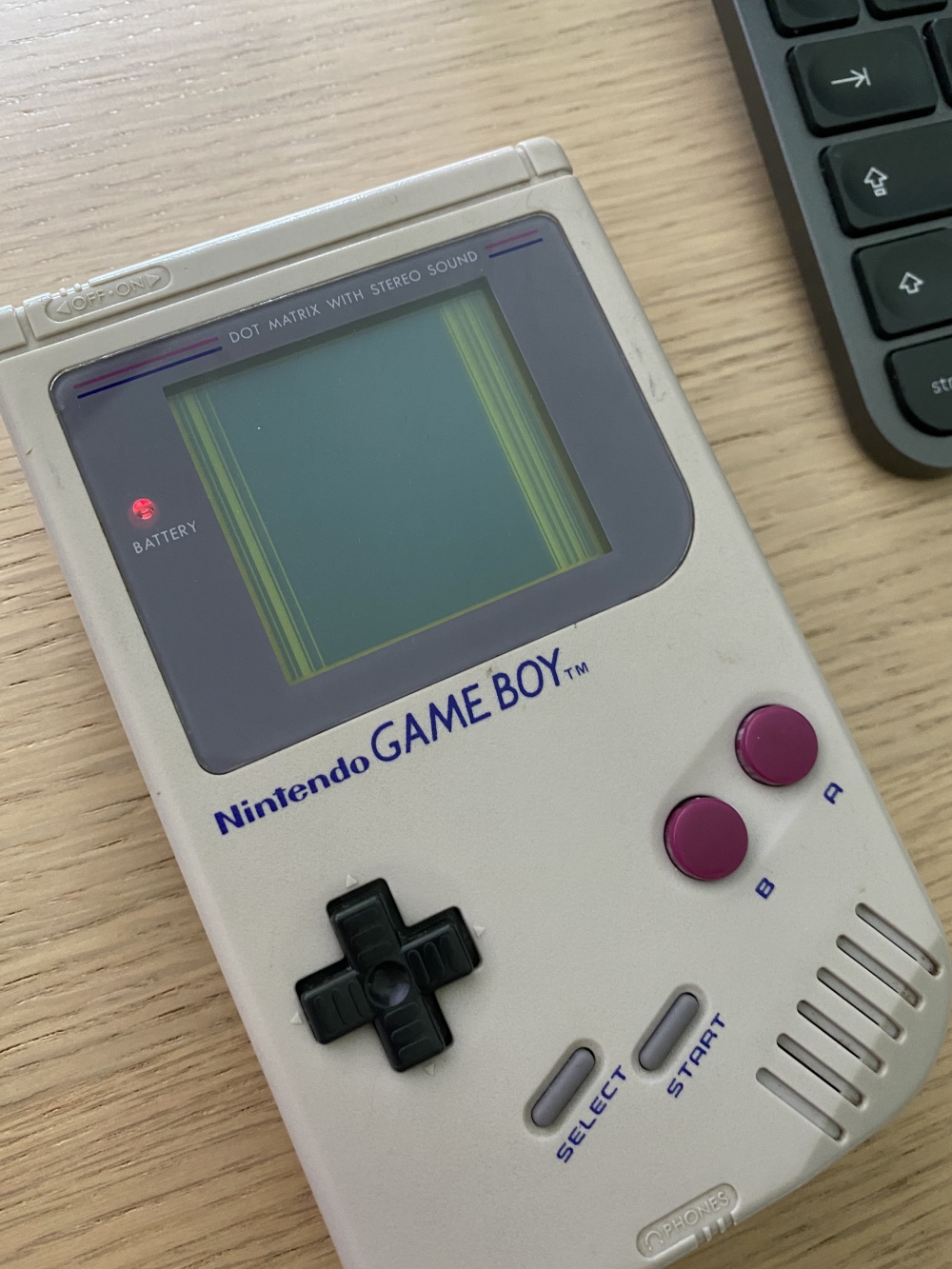 Game Boy with display stripes on black background