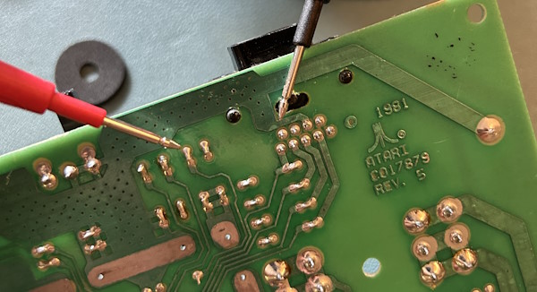 Testing the broken fire button trace with a multimeter